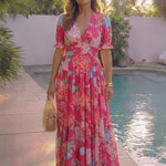 Pink floral V-neck midi dress with short puff sleeves, tiered skirt, and lightweight fabric.
