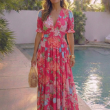 Pink floral V-neck midi dress with short puff sleeves, tiered skirt, and lightweight fabric.