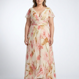 Woman wearing a V-neck, short-sleeve maxi dress in cream chiffon with a pink and brown watercolor floral print.